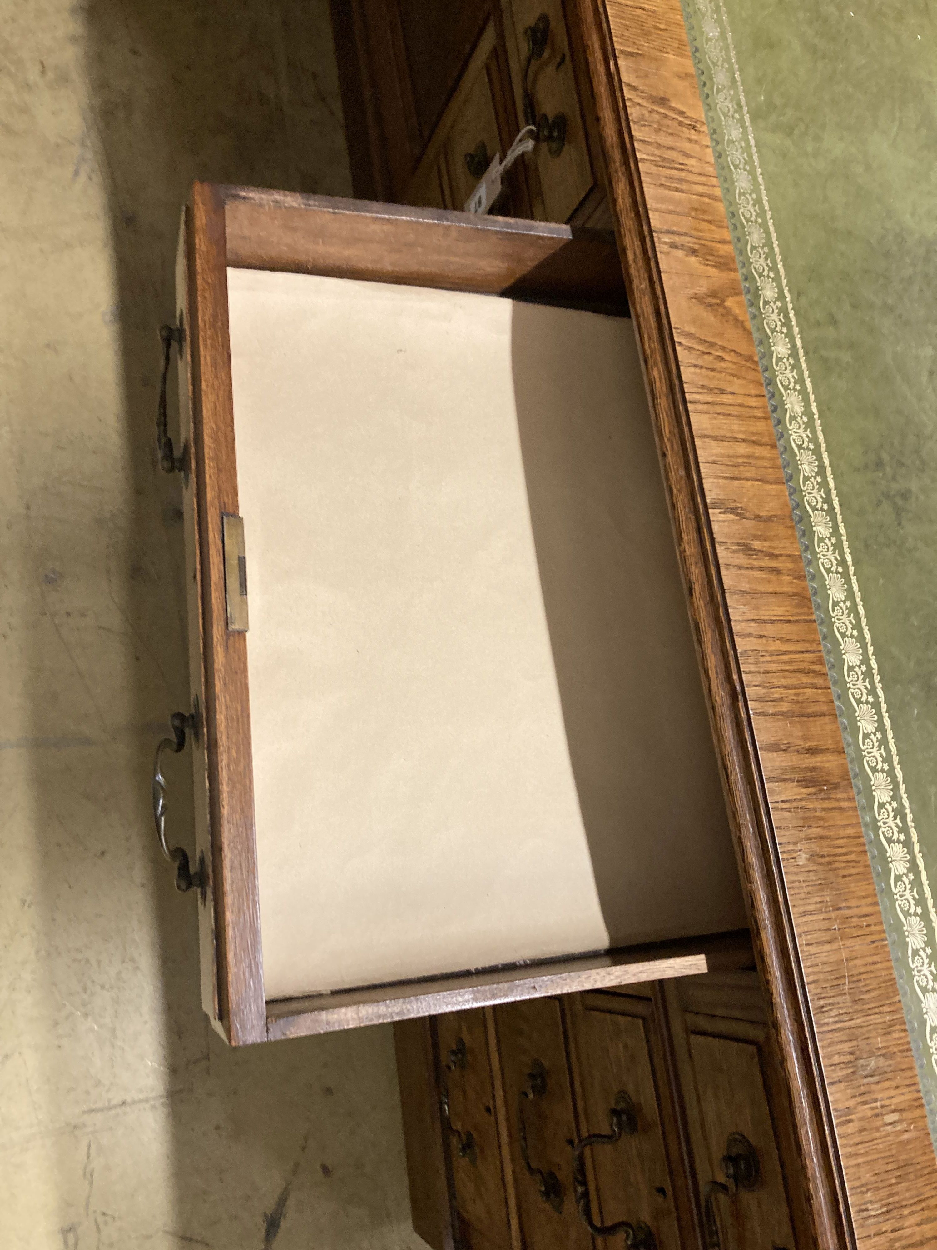 A small Victorian style oak pedestal desk, width 107cm, depth 57cm, height 76cm